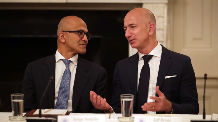 Microsoft CEO Satya Nadella (L) and Amazon CEO Jeff Bezos visit before a meeting of the White House American Technology Council in the State Dining Room of the White House June 19, 2017 in Washington, DC.