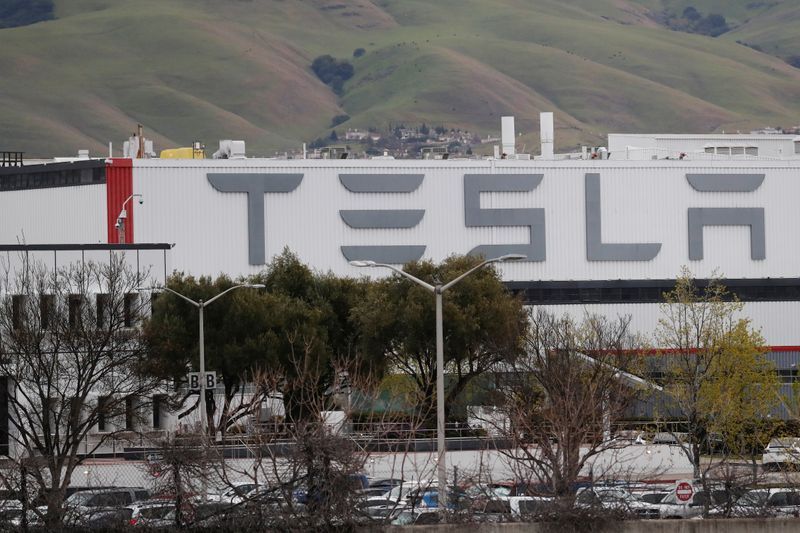 The view of Tesla Inc's U.S. vehicle factory which is open for business, despite an order by the Alameda county's sheriff's office to comply with a three-week lockdown in the San Francisco Bay Area, in order to rein in the spread of coronavirus disease (COVID), in Fremont, California, U.S., March 18, 2020. REUTERS/Shannon Stapleton