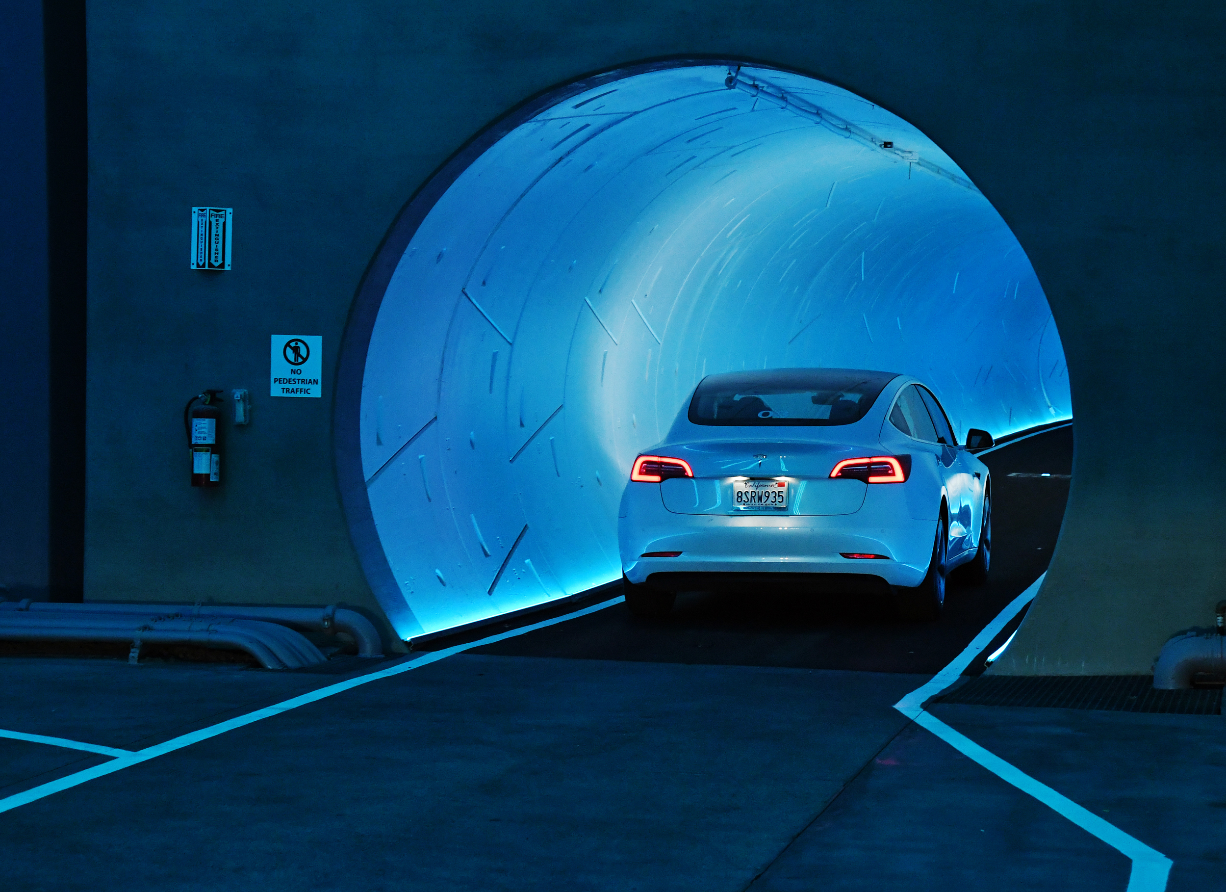 LAS VEGAS, NEVADA - APRIL 09: A Tesla car drives through a tunnel in the Central Station during a media preview of the Las Vegas Convention Center Loop on April 9, 2021 in Las Vegas, Nevada. The Las Vegas Convention Center Loop is an underground transportation system that is the first commercial project by Elon Musk’s The Boring Company. The USD 52.5 million loop, which includes two one-way vehicle tunnels 40 feet beneath the ground and three passenger stations, will take convention attendees across the 200-acre convention campus for free in all-electric Tesla vehicles in under two minutes. To walk that distance can take upward of 25 minutes. The system is designed to carry 4,400 people per hour using a fleet of 62 vehicles at maximum capacity. It is scheduled to be fully operational in June when the facility plans to host its first large-scale convention since the COVID-19 shutdown. There are plans to expand the system throughout the resort corridor in the future. (Photo by Ethan Miller/Getty Images)