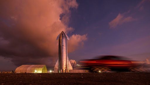 The sky begins to light up before sunrise over a prototype of the SpaceX Starship at the SpaceX launch facility in Boca Chica.(Smiley N. Pool / Staff Photographer)