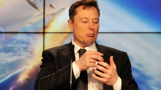 FILE PHOTO: SpaceX founder and chief engineer Elon Musk looks at his mobile phone during a post-launch news conference to discuss the SpaceX Crew Dragon astronaut capsule in-flight abort test at the Kennedy Space Center in Cape Canaveral, Florida, U.S. January 19, 2020. REUTERS/Steve Nesius/File Photo