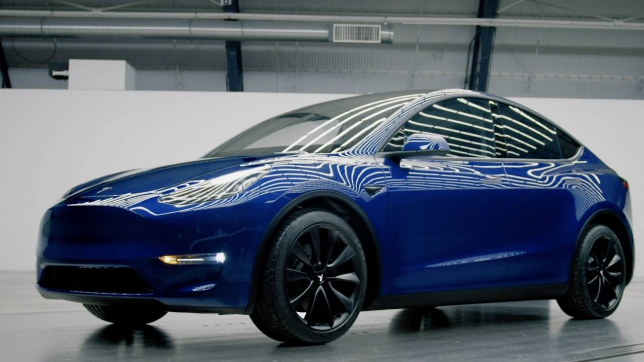 A Model Y SUV exits Tesla's new factory in Germany